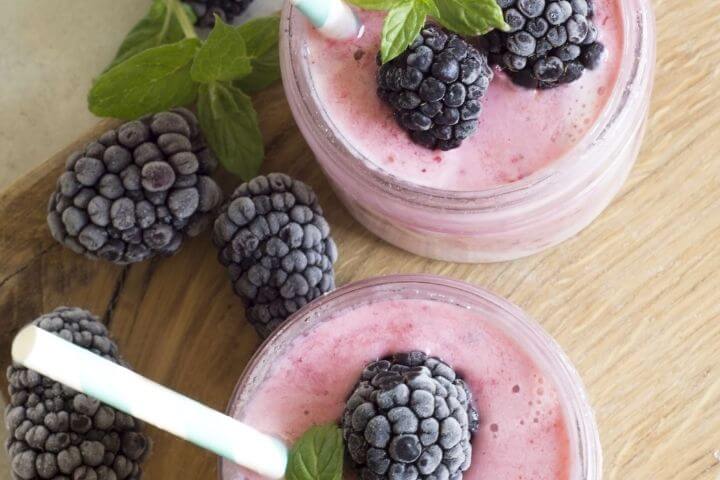 Two glasses filled with berry detox smoothie