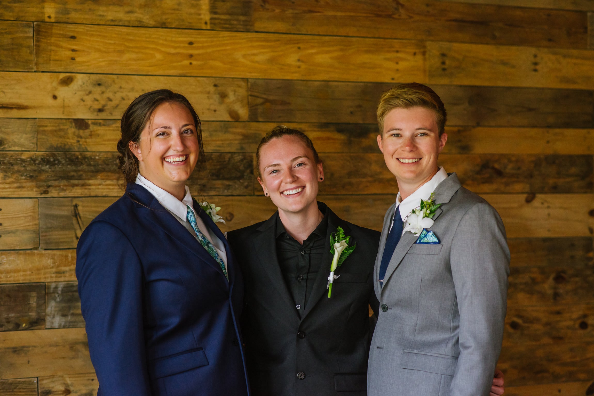 lesbian couple wearing grey and navy suits