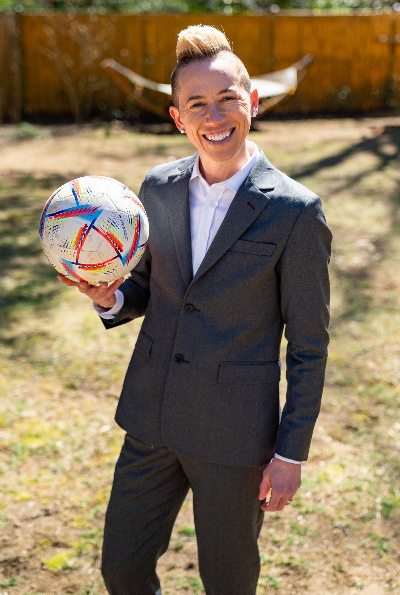 Jo Lohman Holding Soccer Ball in Backyard