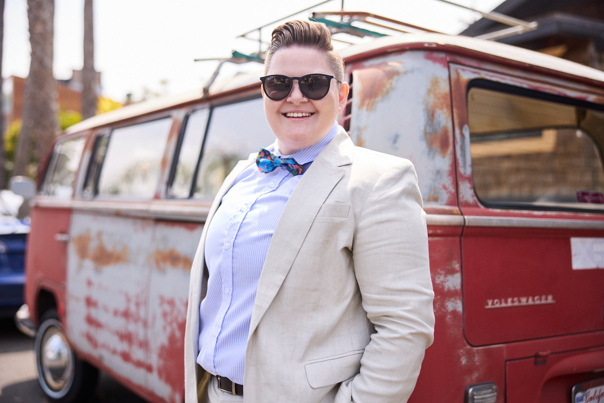 wearing linen suit in front of red truck