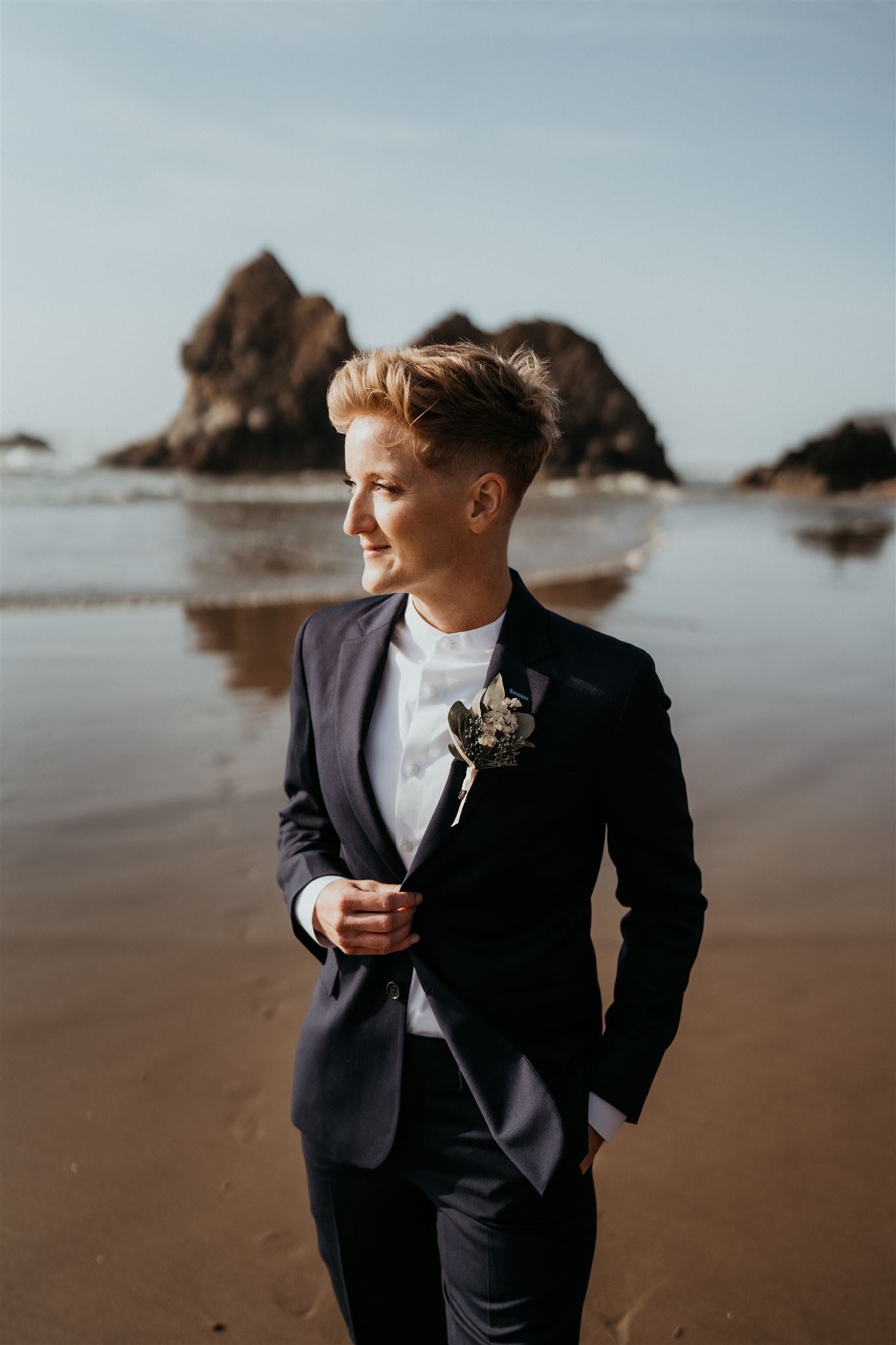 Leslie wearing Kirrin Finch navy suit on the beach 