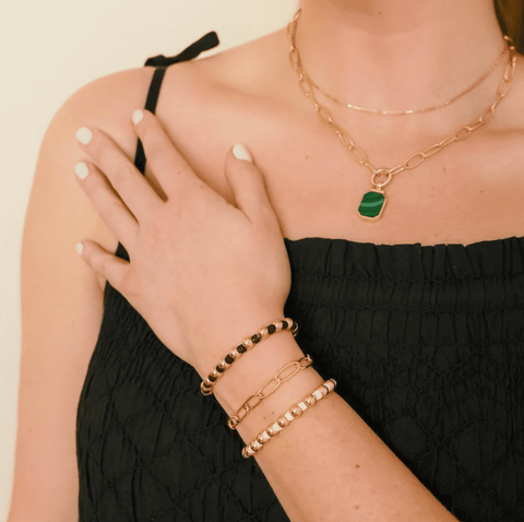 Female wearing our polymer clay disc and gold-filled bead bracelet