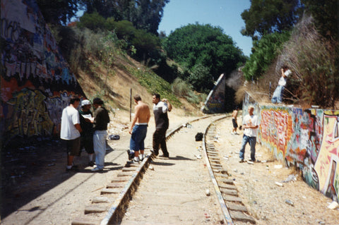 A group of men in an old graffiti yard called Motor yard. Graffiti on the walls.