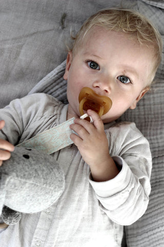 baby with organic soother clip