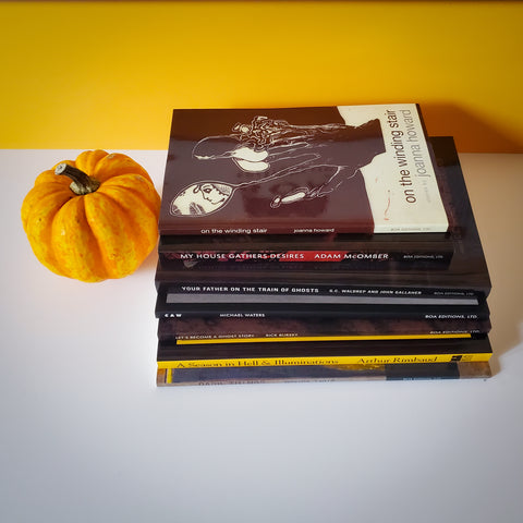 The featured titles are sitting beside a small orange pumpkin with a white and yellow background.