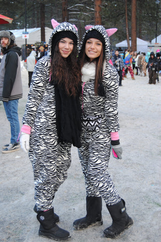 rave girls wearing matching zebra onesies 