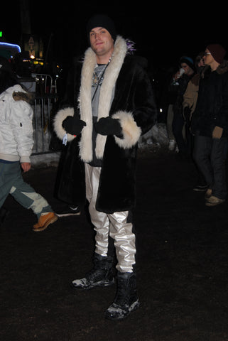rave boy wearing large fur coat at snowglobe