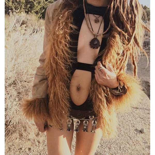 boho styled rave girl wearing black cutout bodysuit