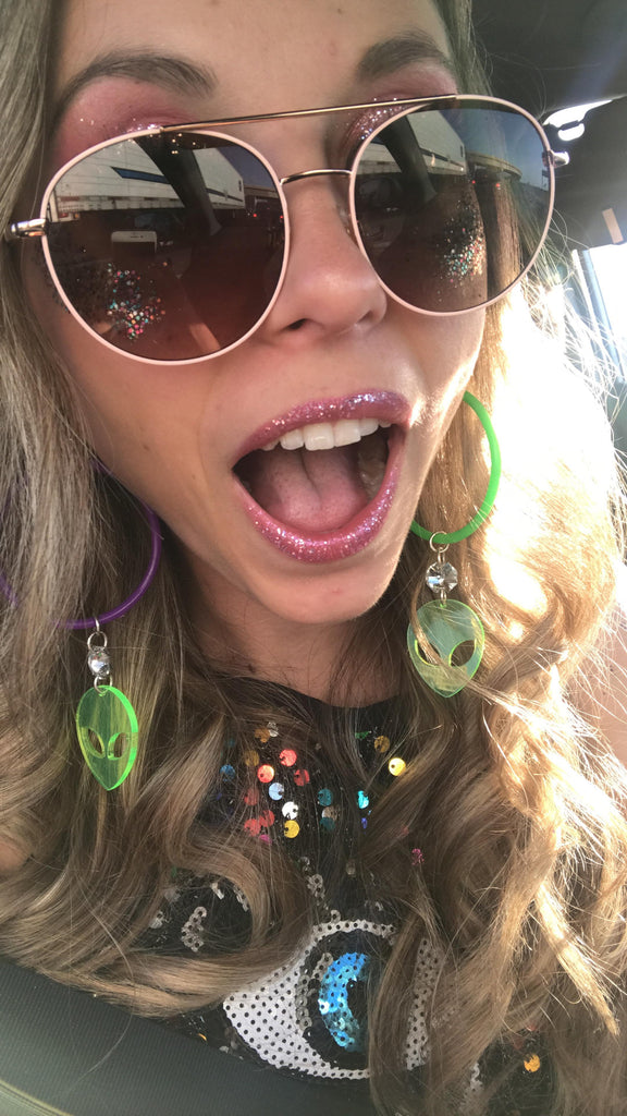 Girl Wearing Alien Hoop Earrings, sparkly lipstick and oversized alien glasses