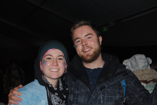 rave couple wearing matching glitter at snowglobe