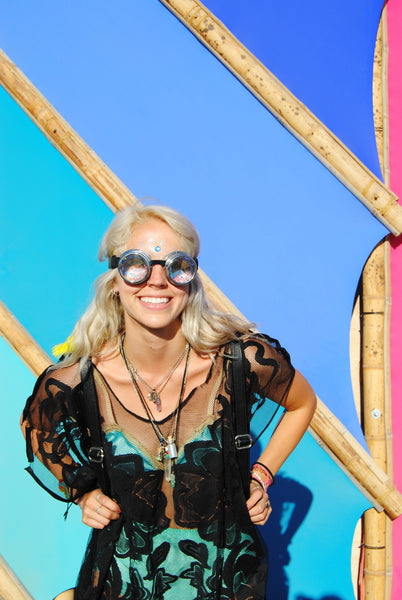 happy rave girl in iridescent goggles at lightning in a bottle 