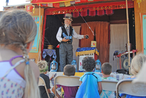 toddlers enjoy magic show at lightning in a bottle
