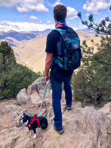 hiker with INTO THE AM backpack