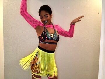 raver wearing a perler necklace, neon fringe skirt and pink mesh crop top