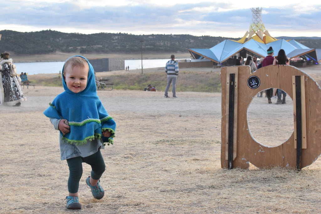 Toddler playing at Lightning in a Bottle Music Festival