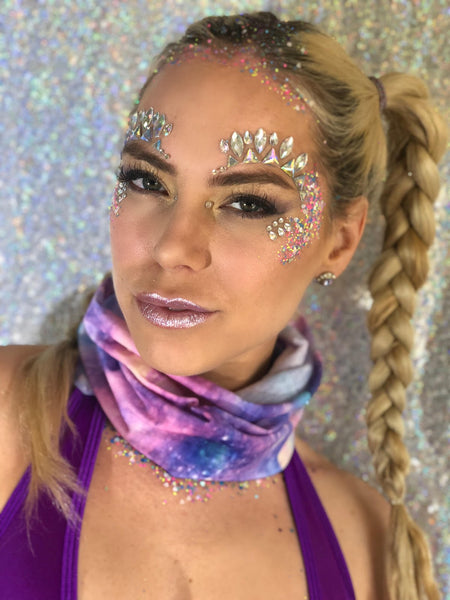 Girl with braided pony tail with a galaxy print seamless mask and face gems around the eyes 