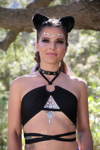 Rave girl wearing Black Wrap around top and black faux leather choker with grommets, black fuzzy cat ears, and festival chest jewel