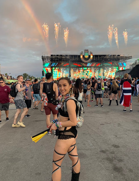 Raver Standing in Front of Rainbow during Sunset At Ultra Music Festival