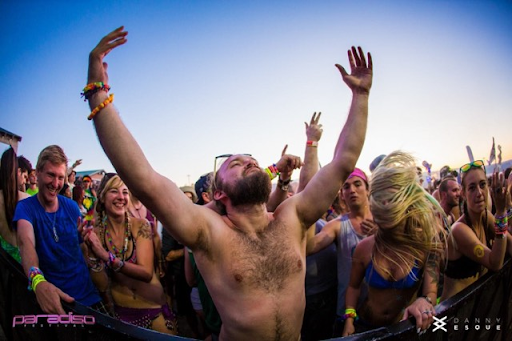 Raver throwing his arms up at Paradiso Festival