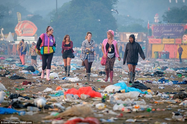 ravers walk through destroyed festival grounds