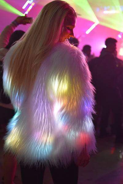 rave girl wearing white LED fluffy jacket