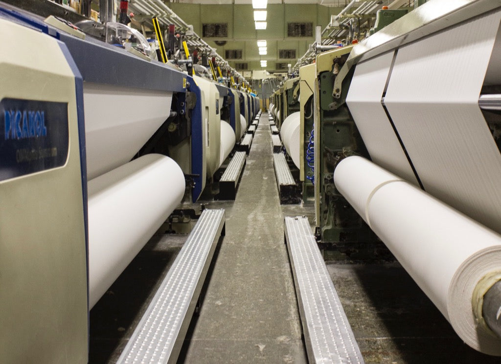 A wall of looms for weaving fabric in the USA. A manufacturing work of art.