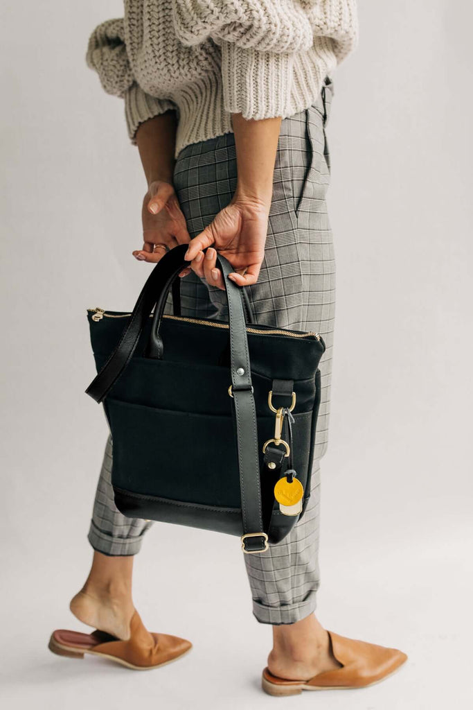 Woman carrying leather/canvas handbag by R. Riveter, 100% Made in USA Gift guide for mother's day