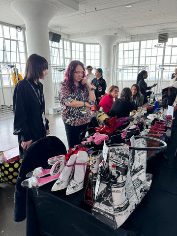 Chantal Pilon backstage deciding which shoes to walk the runway