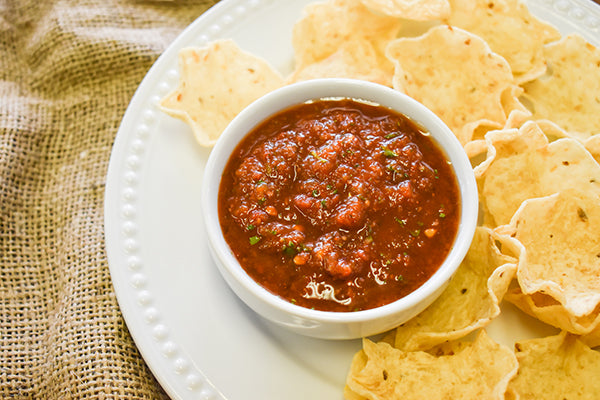 easy homemade salsa in bowl with tortilla chips beside it