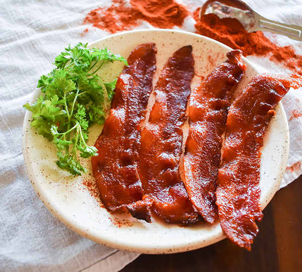 bacon candy on plate with chili seasoning