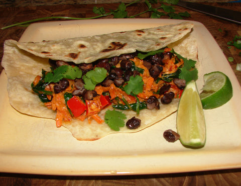 Veggie Taco on place with lime and cilantro garnish