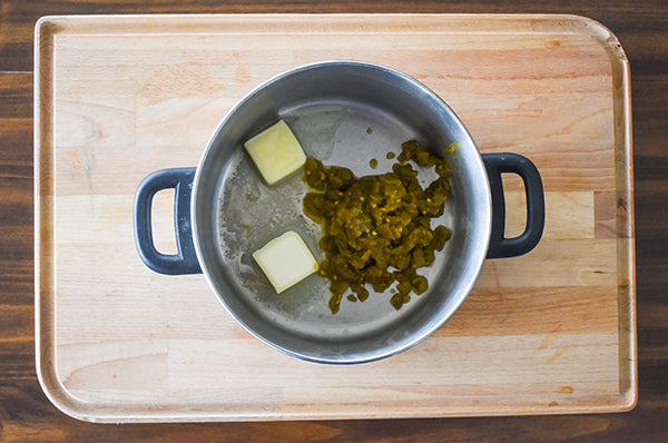 butter and diced green chilies in a pot