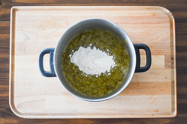 flour added into pot with sauteed diced green chilies