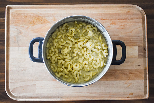 macaroni noodles mixed with cheese sauce in pot