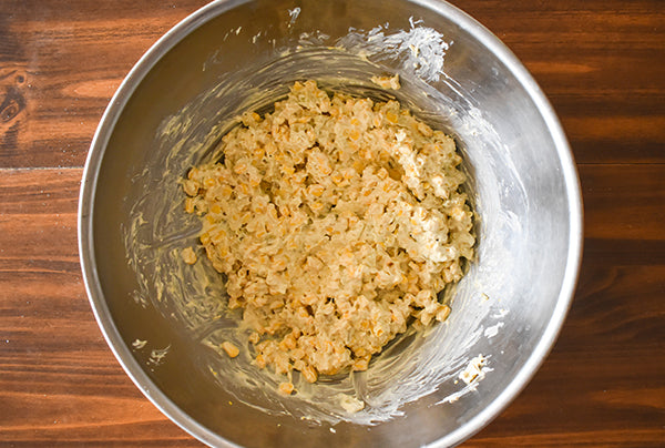 creamy corn in bowl ready to be transferred for baking