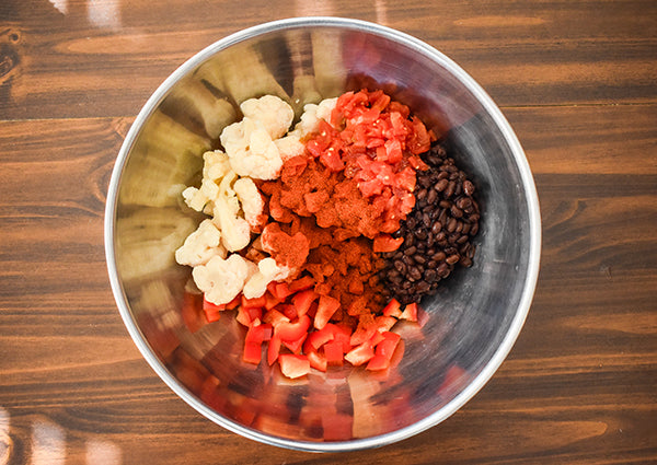 frozen cauliflower, diced tomatoes with green chilies, black beans, diced red bell pepper, chugwater chili seasoning added to mixing bowl