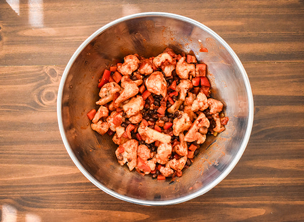 cauliflower mixture for the base mixed together in bowl