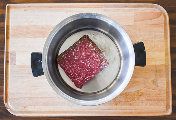 ground bison in pan ready to be cooked 