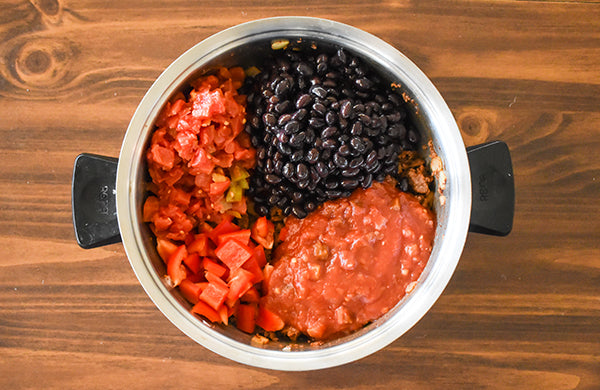 diced bell pepper, canned tomatoes with green chilies, and black bean added to pot