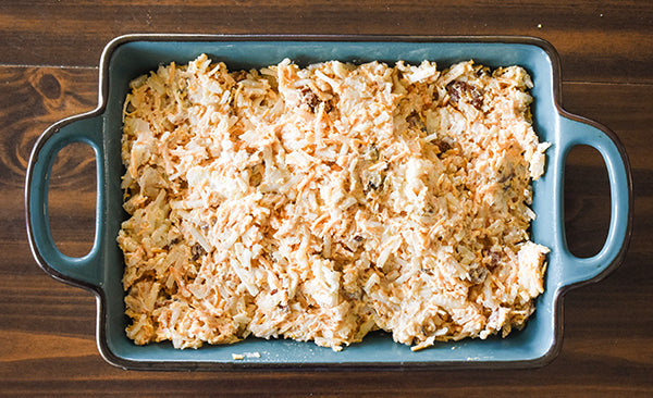 loaded cheesy hasbrowns in baking dish 