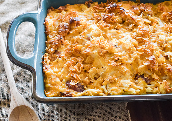 loaded cheesy hasbrowns in baking dish ready to eat