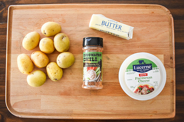 ingredients for parmesan crusted potatoes mini baby potatoes, chugwater chili dip & dressing mix, butter, and grated parmesan cheese