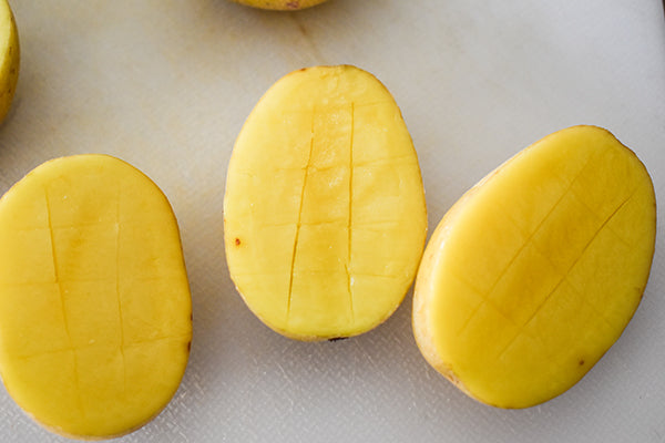 mini potatoes sliced on bottom in cross hatch patter