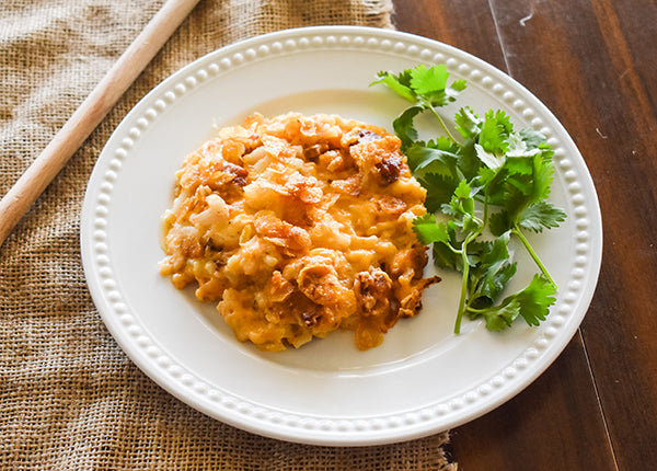 loaded cheesy hashbrowns on plate ready to eat