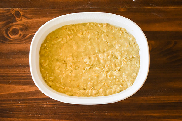 green chile cornbread mix in baking dish ready to bake
