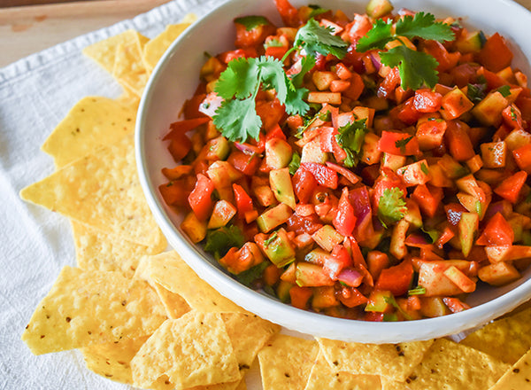 cucumber salsa in bowl with tortilla chips