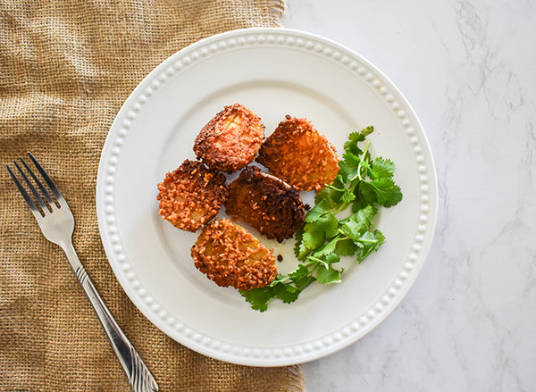 parmesan crusted potatoes on plate ready to eat