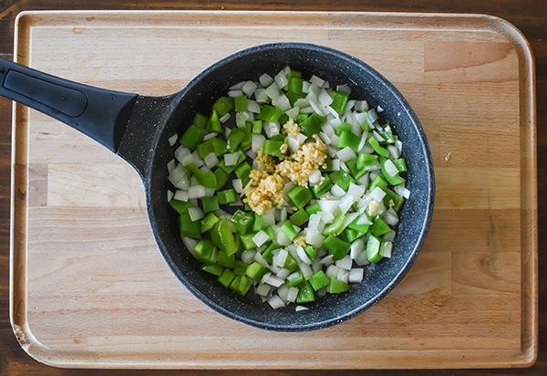 minced garlic added to skillet with sautéed onion and bell pepper