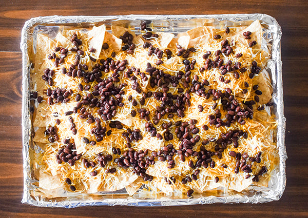 black beans added on top of the tortilla chips and cheese