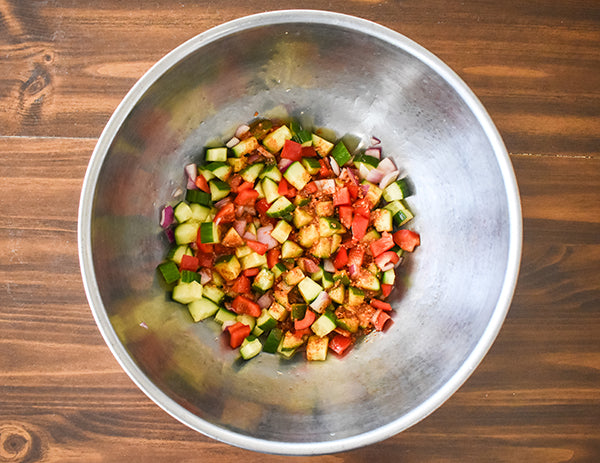 vinaigrette poured on vegetables in bowl